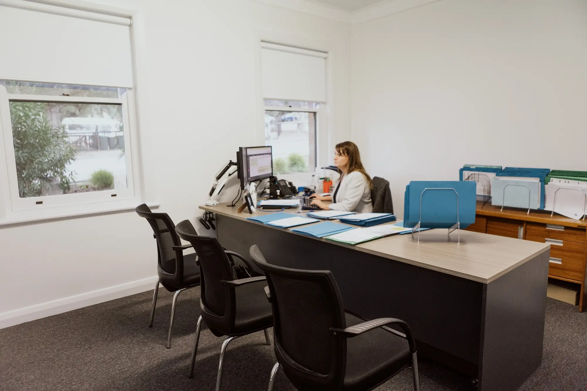 Employee writing notes on conveyancing desk in Adelaide, South Australia.